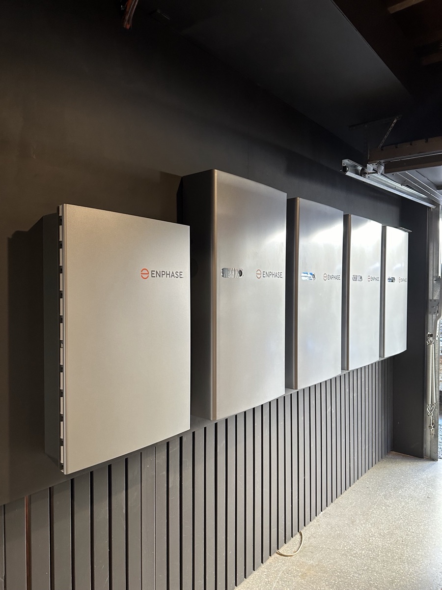 Five wall-mounted home batteries in a Highgate Hill garage